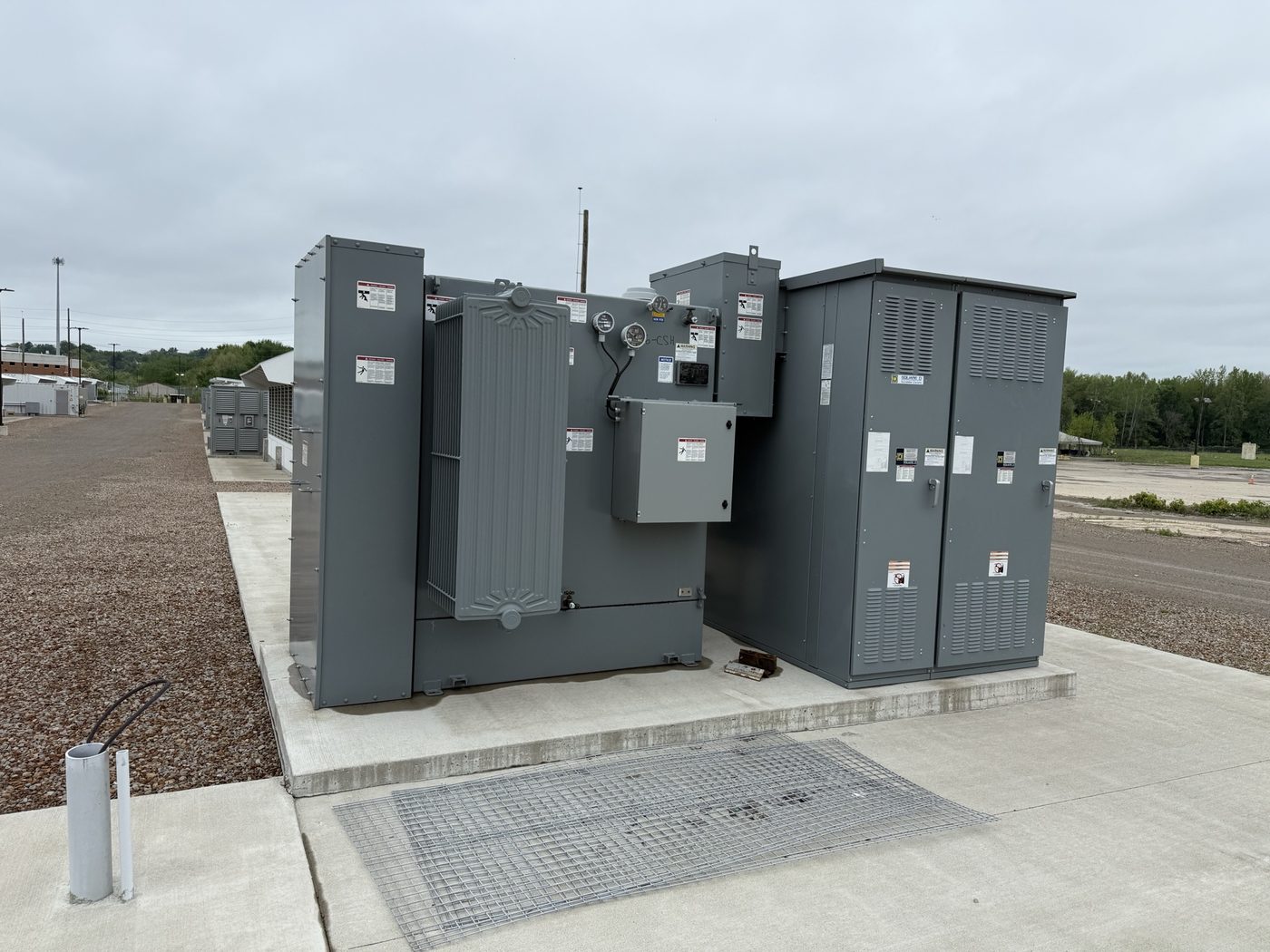 Padmount transformer and switchgear purchased from an industrial site, staged on a concrete pad